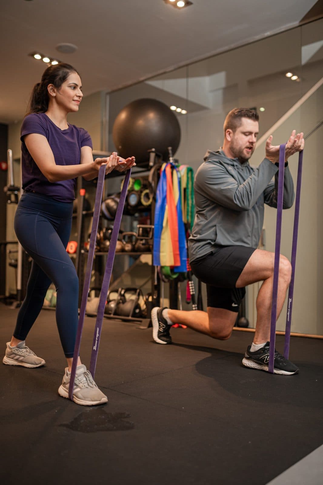 Personal trainer in Clapham coaching a client through a resistance band exercise